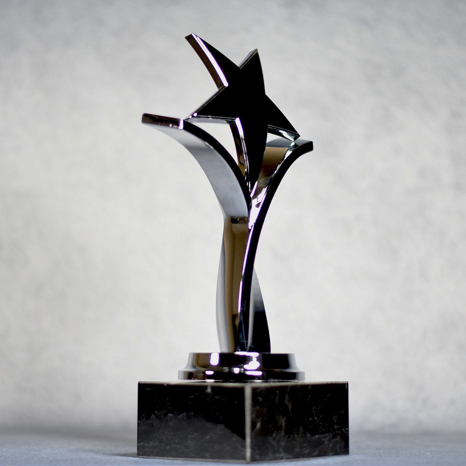 Trophy with Twisting Star on Black Marble Base - - Nothers
